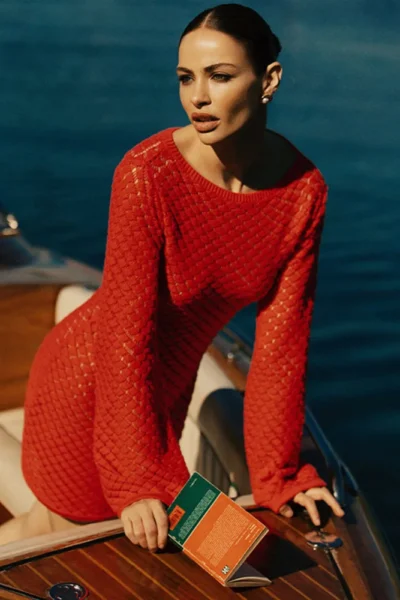 Red knit mini dress with long sleeves on lounge chairRed knit mini dress with long sleeves on lounge chair