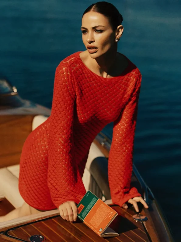 Red knit mini dress with long sleeves on lounge chairRed knit mini dress with long sleeves on lounge chair
