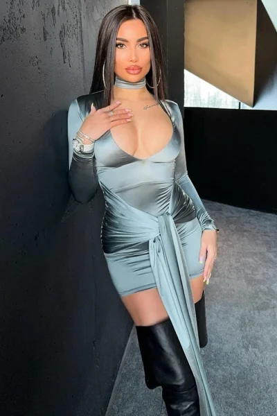 Woman in metallic silver ruched bodycon mini dress front view