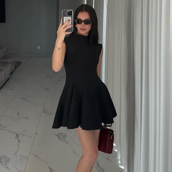 Black high collar sleeveless mini dress displayed flat
