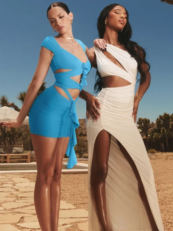 Two women wearing elegant party dresses, one in sky blue mini dress