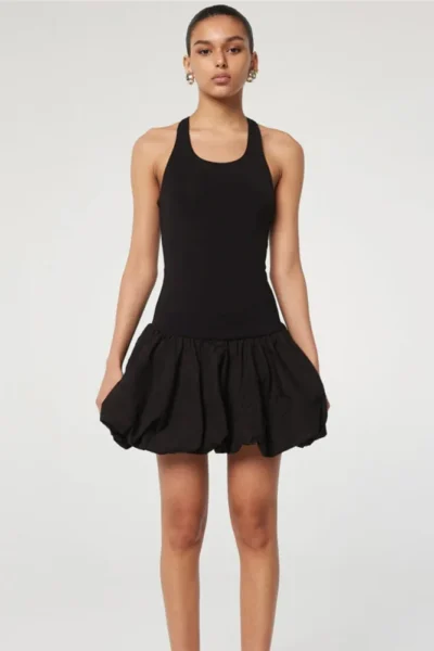 Black sleeveless puffy mini dress on stairs