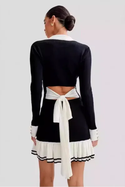 Back of black v-neck knit mini dress with tie detail