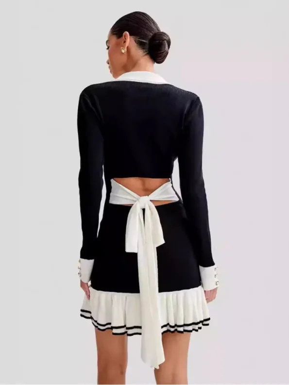 Back of black v-neck knit mini dress with tie detail