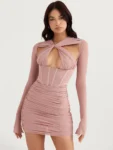 Woman in blush pink hollow-out ruched mini dress