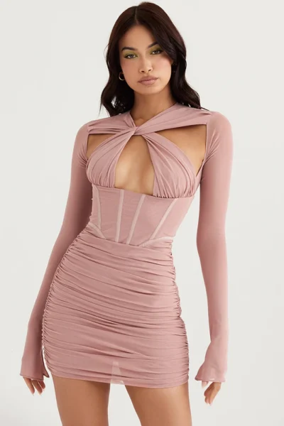 Woman in blush pink hollow-out ruched mini dress