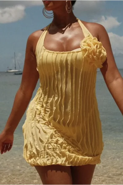 Yellow halter floral pleated mini dress walking outdoors