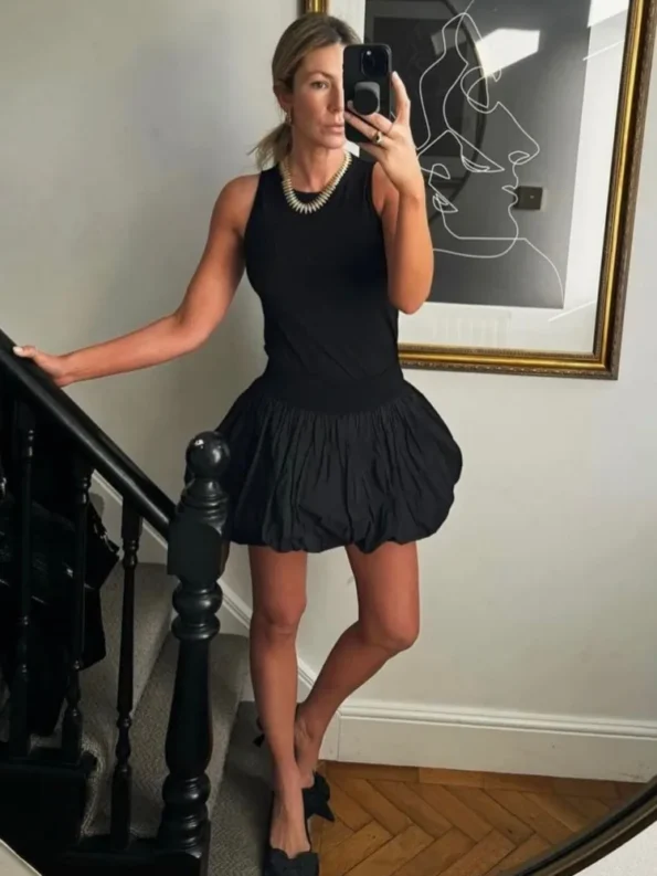 Black sleeveless puffy mini dress front view