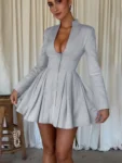 Woman wearing gray long sleeve V-neck pleated mini dress